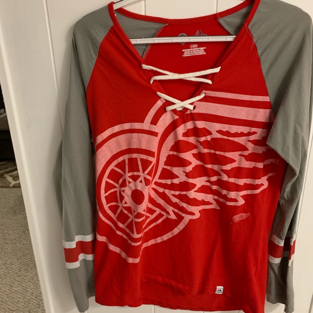 Red wings shirt with criss cross on chest . Large